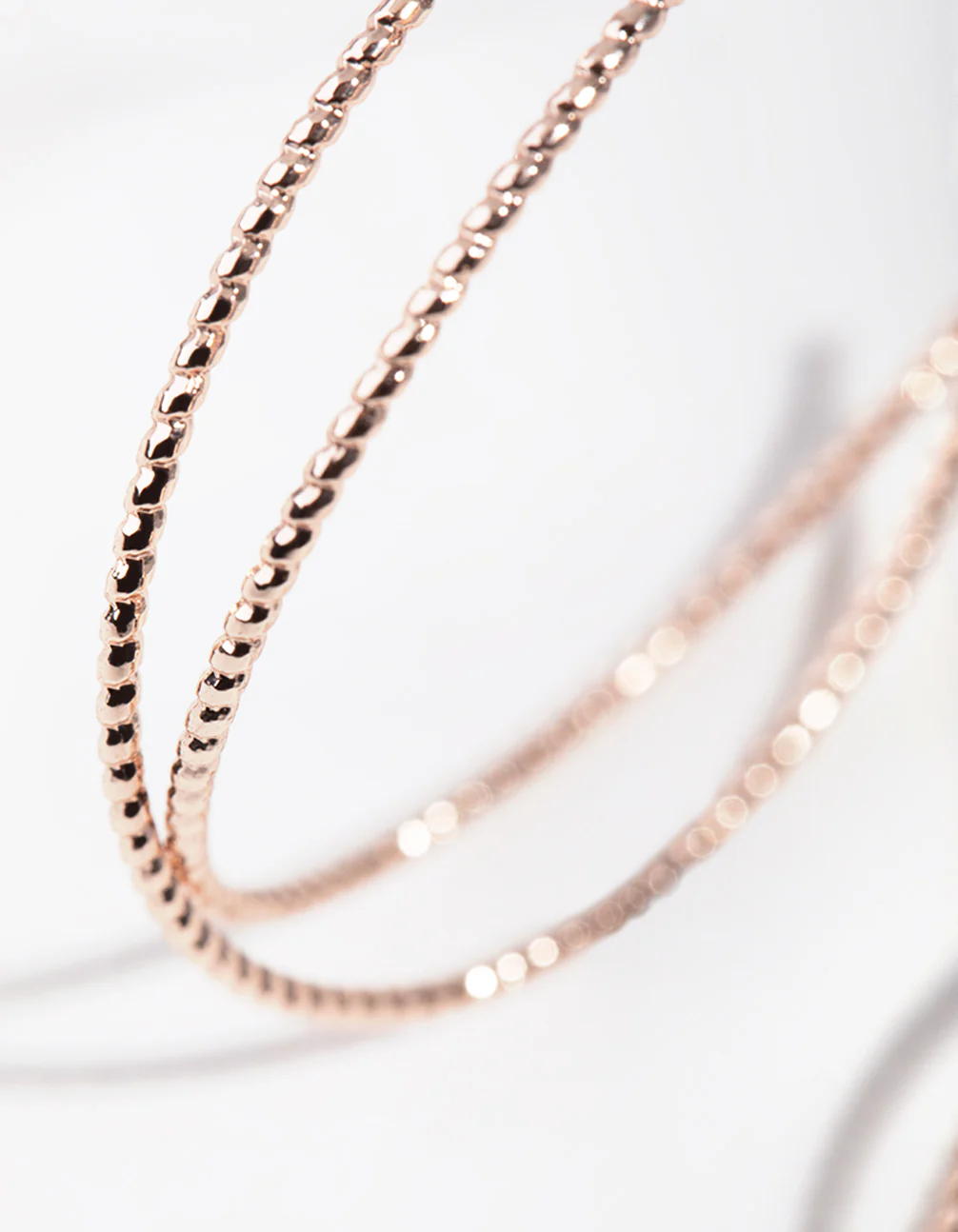 Rose Gold Crossover Hoop Earrings - Image 3